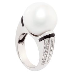 The South Sea pearl and diamond cocktail ring features a pearl of 17mm diameter. The pearl is untreated. It displays a fine nacre and its natural color and luster have not been enhanced in any way. The pearl is highly exposed in a symmetrical ring design set with custom cut calibrated baguette diamonds (0.52 carats) flanked by a row of pavé set round diamonds (0.50 carats). All diamonds are of top quality (F/G-VVS, color, clarity and cut). The design is complete with 2 strips of custom cut black onyx, lending the jewel a distinctive art déco look. The ring is one-of-a-kind. It was handmade in Italy by maestro Giuseppe according to an original design by Ella Gafter. The item is signed EG. Diamond Rings Design, Baguette Diamonds, Diamond Cocktail Rings, Sea Pearl, Modern Ring, Sea Pearls, South Sea Pearls, South Seas, Design Set