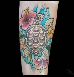 a turtle and flowers tattoo on the leg