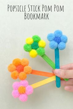 this popsicle stick pom - pom bookmark is so cute and easy to make