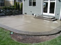 a concrete patio in front of a house