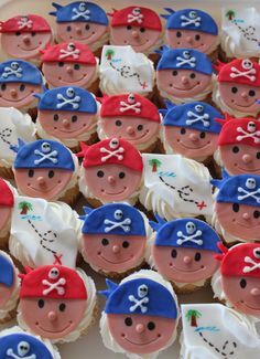 cupcakes decorated with pirate faces are arranged in rows