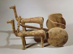 an assortment of wooden objects including a bowl and two giraffes