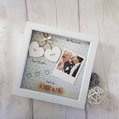 a photo frame with two hearts and the words i love you written on it, surrounded by other items