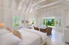 a large bedroom with white walls and ceiling