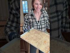 a woman holding a tray of food in her hands