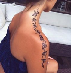 a woman with a tattoo on her back