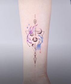 a woman's arm with a tattoo on it that has an arrow and two faces