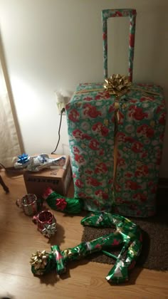 a wrapped present sitting on the floor next to other presents