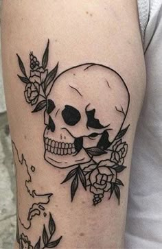 a black and white skull with flowers on it's arm, next to a rose