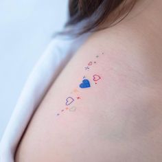 the back of a woman's breast with hearts and stars on her left side