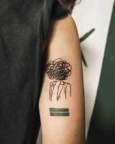 a woman's arm with a tattoo on it that has flowers in the middle