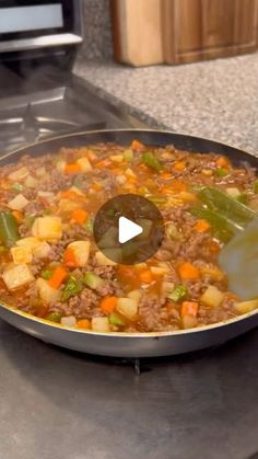 a pan filled with food sitting on top of a stove