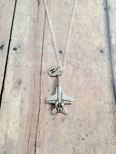 "This listing is for a hand stamped initial necklace featuring a 4/5\" x 4/5\" pewter fighter jet charm & 3/10\" stainless steel initial pendant. The silver plated chain is 18\" long, but can be made to your desired length- see photo. Please indicate chain length you would like in the 'notes to seller' section at checkout. All items are lead & nickel free. Message me with any questions, thank you! Add an initial to any necklace: https://www.etsy.com/listing/170461597/add-an-initial?ref=s Plane Jewelry, Jet Jewelry, Military Necklace, Military Jewelry, Personalized Gold Necklace, Mommy Jewelry, Gold Name Necklace, Bird Necklace, Initial Pendant