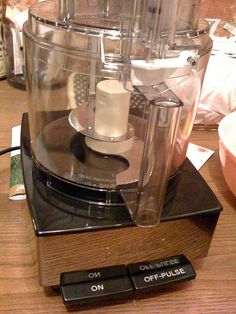 a food processor sitting on top of a wooden table