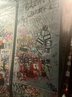 the wall is covered with graffiti and other things