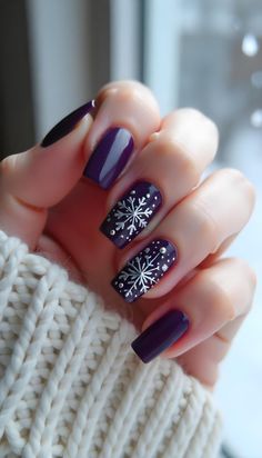 Explore festive nail designs perfect for the holiday season, featuring Christmas trees, snowflakes, and more. Purple Christmas Nails Design, Purple Nails With Snowflakes, Purple Christmas Nails Short, Christmas Nail Art Snowflake, Lilac Winter Nails, Dark Purple Christmas Nails, Christmas Nails Short Snowflake, Holiday Nails Purple, Purple Christmas Nails Acrylic