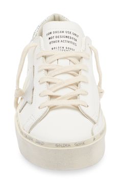 A metallic star and glittery counter dazzle on a leather sneaker detailed with a prescuffed platform sole and handwritten logo lettering around the foxing. Lace-up style Leather upper/leather and textile lining/rubber sole Made in Italy Designer Shoes White Leather Sneakers With Foil Embossed Logo, Golden Goose Hi Star, Handwritten Logo, Top Sneakers Women, Golden Goose Deluxe Brand, Golden Goose, Letter Logo, Up Styles, White Silver