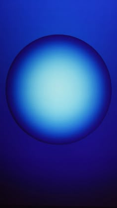 an oval blue object is in the middle of dark blue background with no visible light