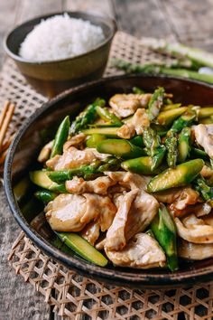 chicken and asparagus stir fry with rice in a bowl