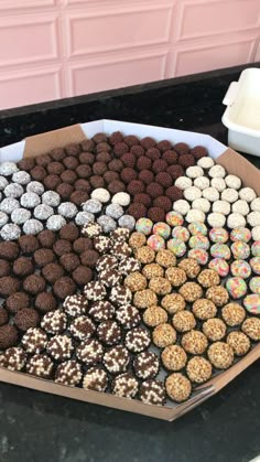 a box filled with lots of different types of chocolates on top of a counter