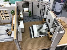 a model of a bedroom and kitchen in a dollhouse style house with furniture on the floor