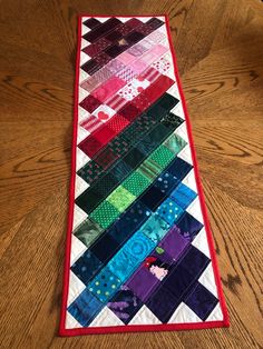 a quilted table runner on a wooden floor