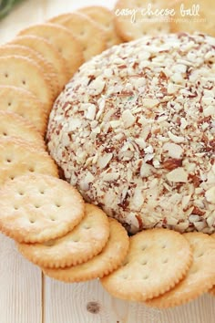 a cheese ball surrounded by crackers on a plate