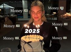 a woman blowing out candles on a birthday cake with the words money written across it