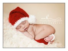 a newborn baby wearing a santa hat