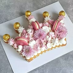 a decorated cake with pink and white frosting on a card that says happy birthday