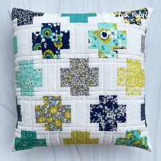 a decorative pillow made from patchwork fabric