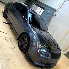 a car parked in a garage next to a building