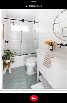 a bathroom with a toilet, sink and shower stall is pictured in this image from the inside