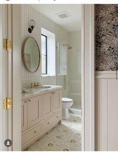 a bathroom with a sink, toilet and mirror