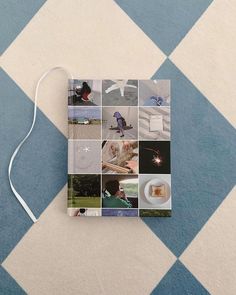 a book with pictures on it sitting on the floor in front of a blue and white checkered wall