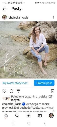 a woman sitting on top of a rock next to water