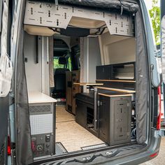 the interior of a van with its doors open and equipment in it's cargo area