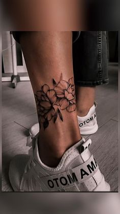 a person with a flower tattoo on their foot