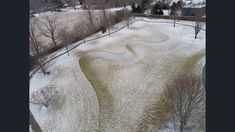 an aerial view of a snow covered field