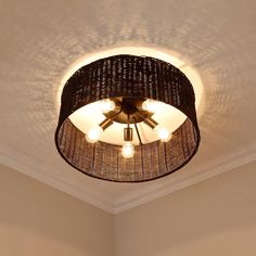 a ceiling light that is hanging from the ceiling in a room with white walls and ceilings