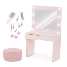 a pink vanity with lights and accessories on it