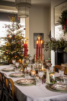 a dining room table set for christmas dinner