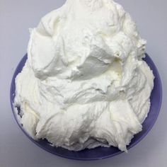 a blue plate topped with whipped cream on top of a table