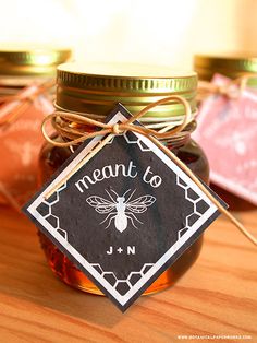 a mason jar filled with jam sitting on top of a wooden table