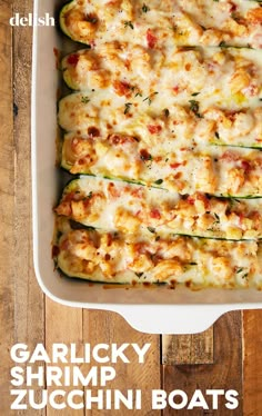 a casserole dish with zucchini boats in it on a wooden table