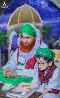 a man with a red beard sitting next to a little boy