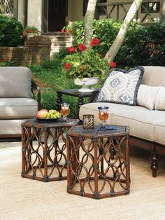 two tables sitting on top of a rug in front of a couch