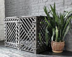 a potted plant sitting on top of a wooden bench next to a brick wall