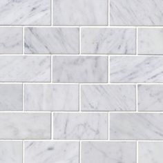 a white marble tile wall that looks like it is made out of bricks