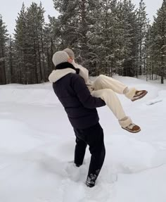 a man in the snow with his feet up